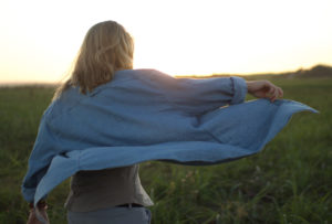 Restored woman rejoicing in an open field