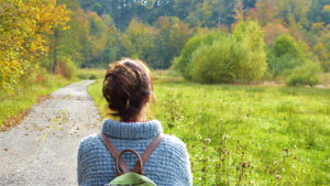 Silent young woman walking outside.