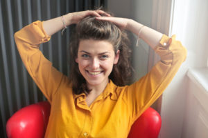 Happiness in young woman sitting with a smile