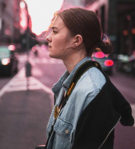 Girl walking in the streets thinking of her value to God.