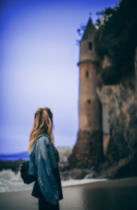 Pondering her full reward. Young woman looking at castle.